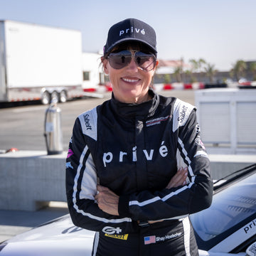 Shay Hoelscher in her privé racing suit with arms crossed